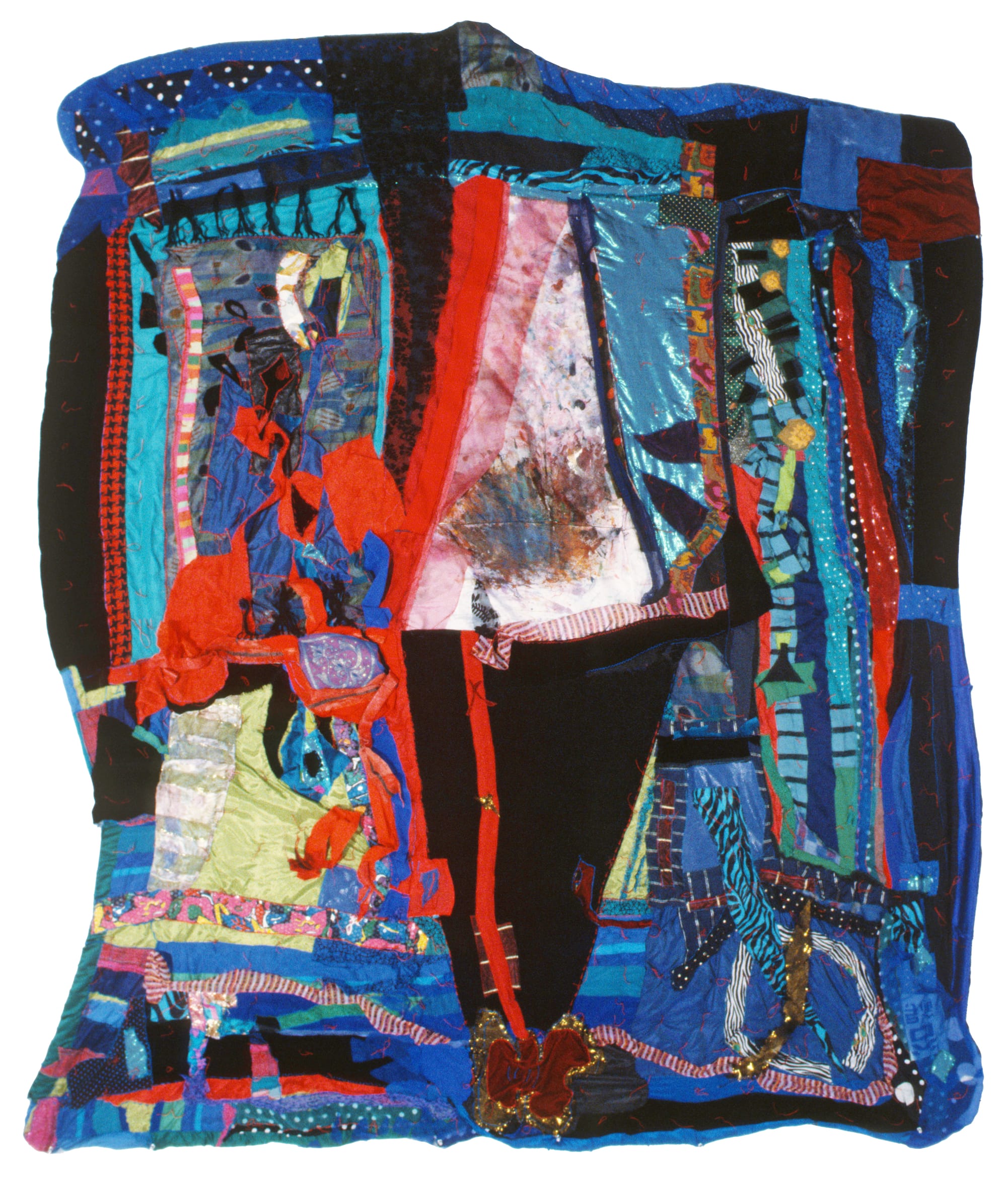 Colorful textile artwork by Janet Echelman made from layered and stitched fabrics in red, blue, and black, forming an abstract patchwork composition.