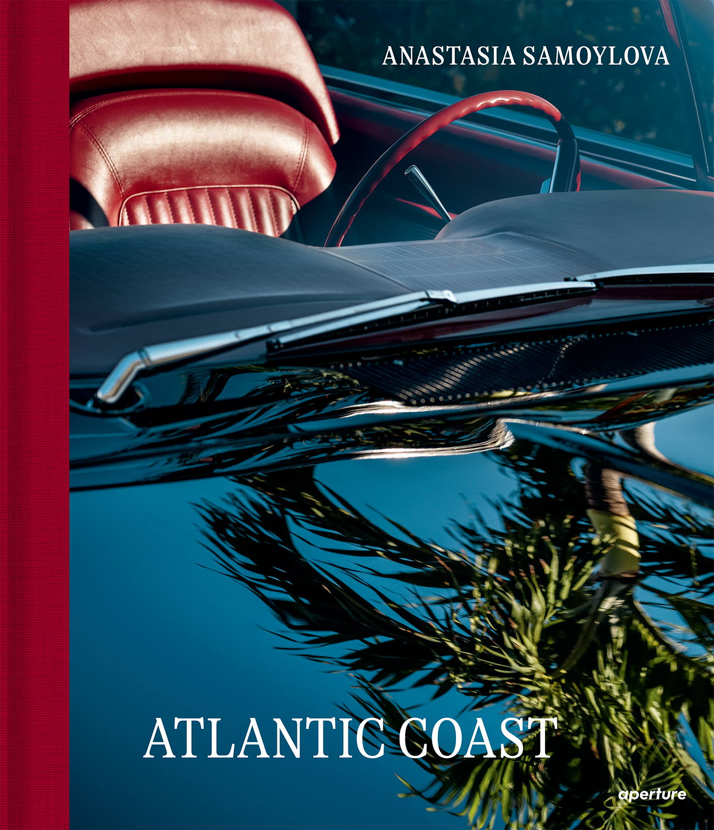 Cover of Atlantic Coast by photographer Anastasia Samoylova, showing the reflection of palm trees in the windshield of a classic red car.