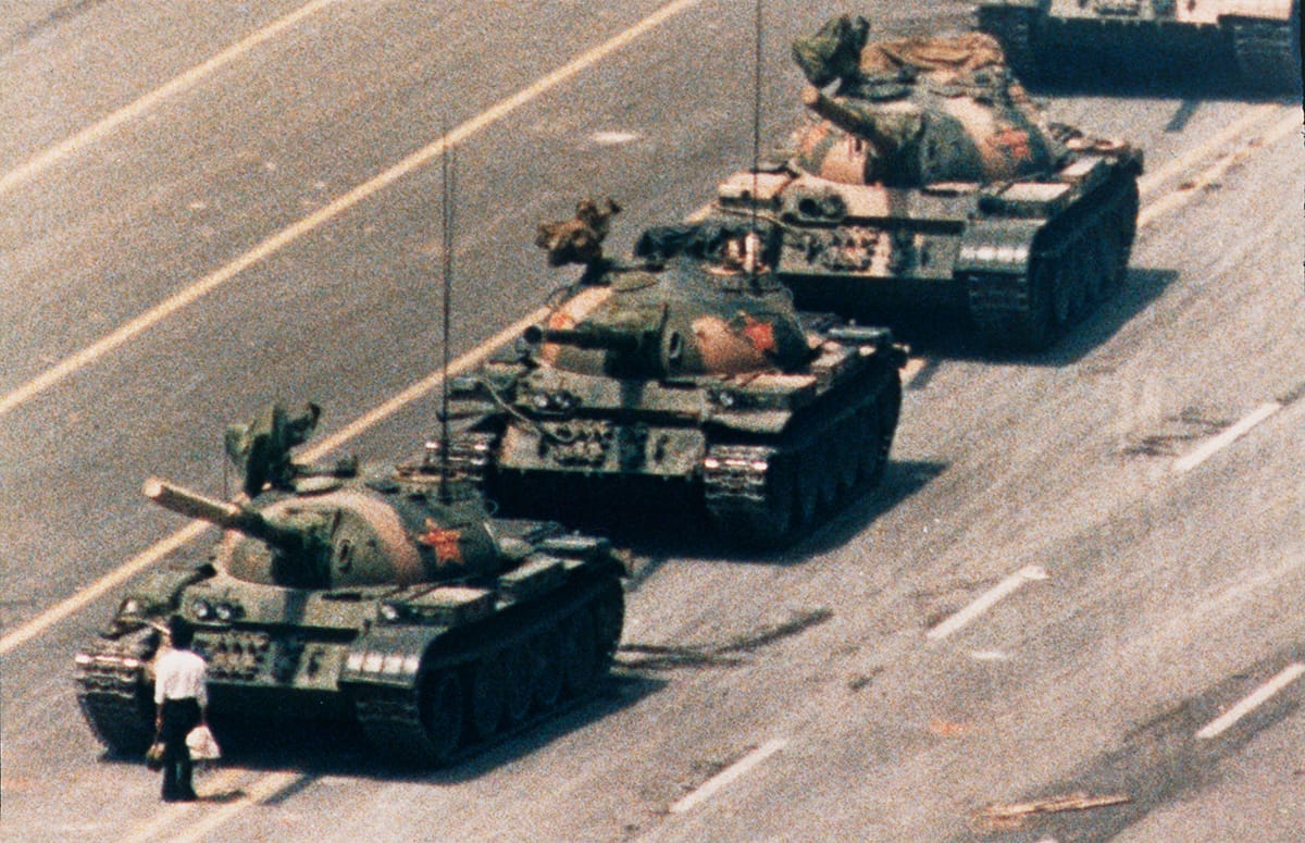 A demonstrator confronts a line of People's Liberation Army tanks 