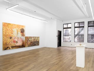 Installation view of The Bed Sitting Room organized by Ginny on Frederick at Lomex, showing artwork on white walls and pedestals in a gallery space