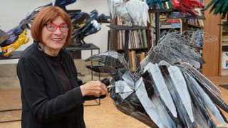 Joan Danziger is pictured in her studio working on one of her raven sculptures