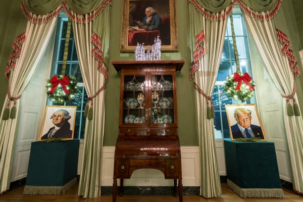 The White House Green Room decorated for Christmas, with two Lego-style portraits—George Washington on the left and Donald Trump on the right