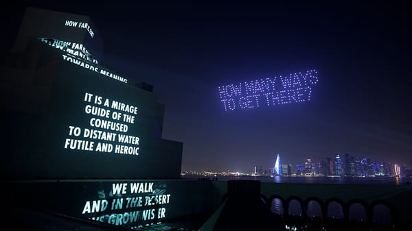 Jenny Holzer’s site-responsive projection and drone artwork SONG illuminates Doha’s Museum of Islamic Art and night sky during Art Basel Qatar, featuring poetic text in Arabic and English.